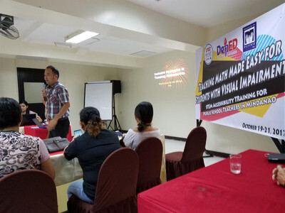 Audience view of man speaking to classroom