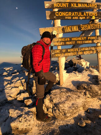 Mr. Reeves stands at top of Mt. Kilimanjaro