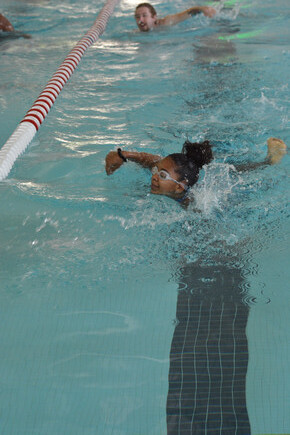 female student swimming in pool