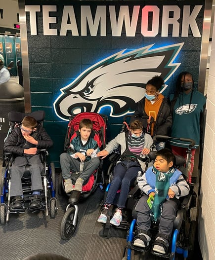 Students in front of teamwork banner