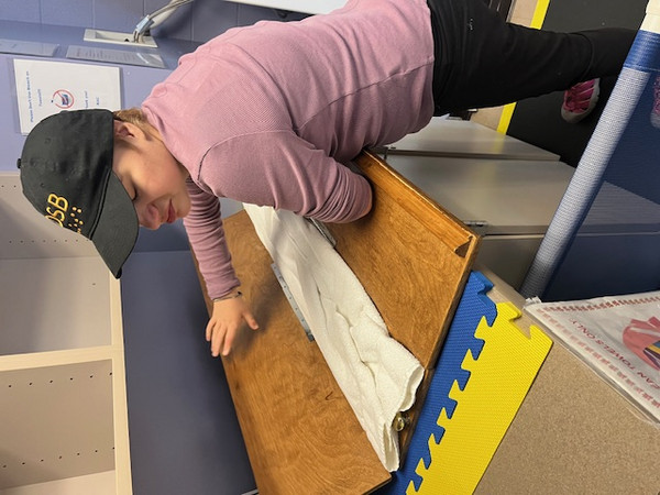 STRIDE student Aeryn Eisner folding a towel at KAC