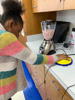 A Middle School student using a blender