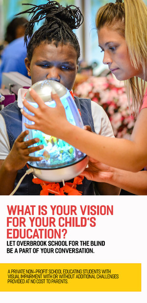 photo of student and teacher looking at small light up aquarium